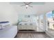 Bright coastal bedroom showcasing a queen bed and day bed near exterior windows at 337 Rex Pl # G, Madeira Beach, FL 33708