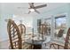 Bright dining area featuring a glass-top table, rattan chairs, and large windows at 337 Rex Pl # G, Madeira Beach, FL 33708