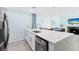 Modern kitchen with white countertops and cabinets, with a spacious island and stainless steel appliances at 337 Rex Pl # G, Madeira Beach, FL 33708