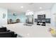 Bright kitchen with stainless steel appliances, large island with bar seating, and stylish blue accents at 337 Rex Pl # G, Madeira Beach, FL 33708