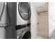 Convenient laundry area adjacent to the bathroom features a stacked washer and dryer at 337 Rex Pl # G, Madeira Beach, FL 33708