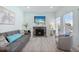 Relaxing living room featuring a cozy fireplace, comfortable seating, and stylish decor at 337 Rex Pl # G, Madeira Beach, FL 33708