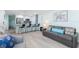 Open-concept living room with kitchen, stainless steel appliances, and bar seating at 337 Rex Pl # G, Madeira Beach, FL 33708