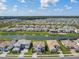 Picturesque aerial view of a residential community with lush landscaping and sparkling lakes throughout at 34084 Torrent Ln, Wesley Chapel, FL 33543