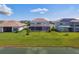 View of backyard featuring a screened-in pool and patio, plus a view of the pond at 34084 Torrent Ln, Wesley Chapel, FL 33543