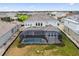 Aerial view of a home with a private screened-in pool and backyard at 34084 Torrent Ln, Wesley Chapel, FL 33543