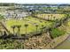 Aerial view of the community park with amenities, surrounded by homes and lush green spaces at 34084 Torrent Ln, Wesley Chapel, FL 33543