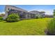 The large backyard features a screened-in pool and patio, plus lush green grass at 34084 Torrent Ln, Wesley Chapel, FL 33543