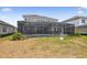 A backyard with a pool and a covered patio at 34084 Torrent Ln, Wesley Chapel, FL 33543