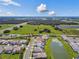 Aerial view of a thoughtfully designed community with a blend of green spaces and serene ponds at 34084 Torrent Ln, Wesley Chapel, FL 33543