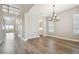 Open dining room with wood floors, modern chandelier, and ample natural light at 34084 Torrent Ln, Wesley Chapel, FL 33543
