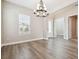 Bright dining area with wood floors and a modern chandelier, ideal for entertaining at 34084 Torrent Ln, Wesley Chapel, FL 33543