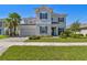 Charming two-story home with paver driveway and lush landscaping at 34084 Torrent Ln, Wesley Chapel, FL 33543