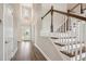 Grand entryway features a staircase with wooden railings and abundant natural light at 34084 Torrent Ln, Wesley Chapel, FL 33543