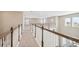 Hallway with wood and white banisters, and carpet flooring at 34084 Torrent Ln, Wesley Chapel, FL 33543