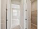 Hallway with neutral walls and trim, with views of the bathroom and closet at 34084 Torrent Ln, Wesley Chapel, FL 33543