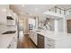 Spacious open kitchen with stainless steel appliances, island, and view of the staircase at 34084 Torrent Ln, Wesley Chapel, FL 33543