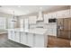 A modern kitchen featuring white cabinetry, stainless steel appliances, and a large center island at 34084 Torrent Ln, Wesley Chapel, FL 33543