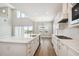 Bright, open kitchen with island, stainless appliances, and access to the outdoors at 34084 Torrent Ln, Wesley Chapel, FL 33543