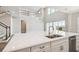 Bright open kitchen with large island, stainless appliances, and large windows at 34084 Torrent Ln, Wesley Chapel, FL 33543
