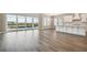 Open living area featuring hardwood floors, bar seating, and access to backyard pool at 34084 Torrent Ln, Wesley Chapel, FL 33543