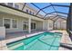 Modern backyard pool with patio and screened in enclosure at 34084 Torrent Ln, Wesley Chapel, FL 33543