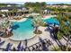 Stunning aerial view of a luxurious community pool with lush landscaping and comfortable lounge chairs at 34084 Torrent Ln, Wesley Chapel, FL 33543