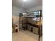 Compact bedroom featuring a lofted bed with desk and storage beneath at 3713 E Clifton St, Tampa, FL 33610