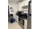 Modern kitchen with white cabinetry, stainless steel appliances, and sleek countertops at 3713 E Clifton St, Tampa, FL 33610