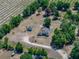 Birds-eye view of the property with a pool, lush trees, and a long, winding driveway at 38824 Raiser Rd, Dade City, FL 33525