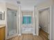 Bathroom featuring a jacuzzi tub, a stand-up shower, classic columns, and updated finishes at 38824 Raiser Rd, Dade City, FL 33525
