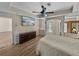 Bright bedroom boasts wood-look tile floors, neutral paint, a ceiling fan, and access to an outdoor pool at 38824 Raiser Rd, Dade City, FL 33525