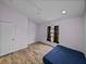 This bedroom features a ceiling fan, window, and light wood-look flooring at 38824 Raiser Rd, Dade City, FL 33525