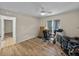 Bright bedroom features wood floors, ceiling fan, and a window with natural light, perfect for an office at 38824 Raiser Rd, Dade City, FL 33525