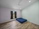 Simple bedroom featuring wood-look tile flooring, light-colored walls, and a window with privacy at 38824 Raiser Rd, Dade City, FL 33525