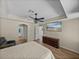 This primary bedroom features wood-look tile, a tray ceiling, and a door to an ensuite bathroom at 38824 Raiser Rd, Dade City, FL 33525