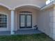 Inviting front entryway with double doors, arched portico, and decorative columns offering curb appeal at 38824 Raiser Rd, Dade City, FL 33525
