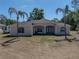 Stately single-story residence with elegant architectural details and verdant palm trees at 38824 Raiser Rd, Dade City, FL 33525