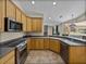 Spacious kitchen featuring stainless appliances, wood cabinetry, and view to the outdoors at 38824 Raiser Rd, Dade City, FL 33525
