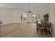 Open-concept living space showcases wood-look tile floors and access to kitchen and outdoor pool at 38824 Raiser Rd, Dade City, FL 33525