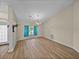 Spacious living area with vaulted ceilings, natural light, and stylish wood-look tile flooring at 38824 Raiser Rd, Dade City, FL 33525