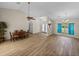 Expansive living area with dining space featuring wood-look tile flooring and bright natural light at 38824 Raiser Rd, Dade City, FL 33525