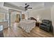 Main bedroom boasting tray ceiling, ceiling fan, and hard surface floors at 38824 Raiser Rd, Dade City, FL 33525