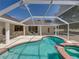This pool and spa combo is the centerpiece of a backyard with a spacious patio for relaxing and entertaining at 38824 Raiser Rd, Dade City, FL 33525