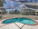Screened pool and hot tub overlooking expansive greenspace, perfect for relaxation and outdoor enjoyment at 38824 Raiser Rd, Dade City, FL 33525
