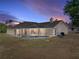 Exterior view showcases a beautiful screened-in pool with a connected hot tub for outdoor enjoyment at 38824 Raiser Rd, Dade City, FL 33525