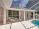 Screened-in patio provides seating and overlooks the pool, creating a perfect space for relaxation and entertaining at 38824 Raiser Rd, Dade City, FL 33525