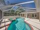 Screened pool and spa surrounded by a spacious patio, ideal for relaxation and entertaining with open backyard views at 38824 Raiser Rd, Dade City, FL 33525
