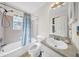 Bathroom features tub with shower, decorative window, and vanity with white basin sink at 4085 37Th N Ave, St Petersburg, FL 33713