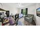 Comfortable bedroom featuring a bed, accent chair, gaming desk, and natural light from the window at 4085 37Th N Ave, St Petersburg, FL 33713